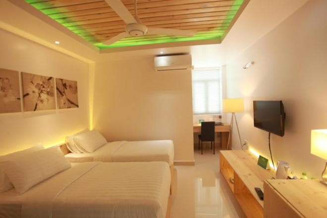Superior Double room with two beds, a wooden ceiling, a desk and a wall-mounted TV